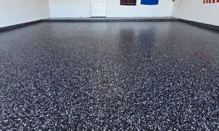 How we epoxy a garage floor in winter in El Paso: raven flake system going down on a slab that cleared 50°F by noon
